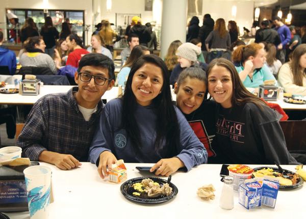 Four students eating breakfast meal