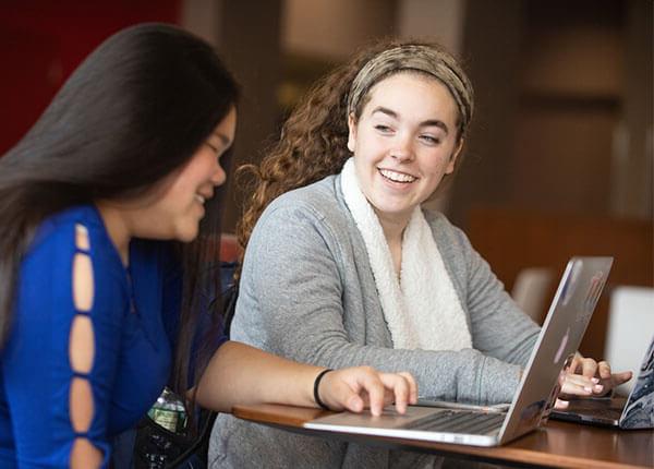 Student interns working together in GSU Hawk Lounge