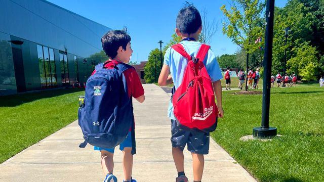 Two Summer Place campers walking towards the Hursey Center at University of Hartford.